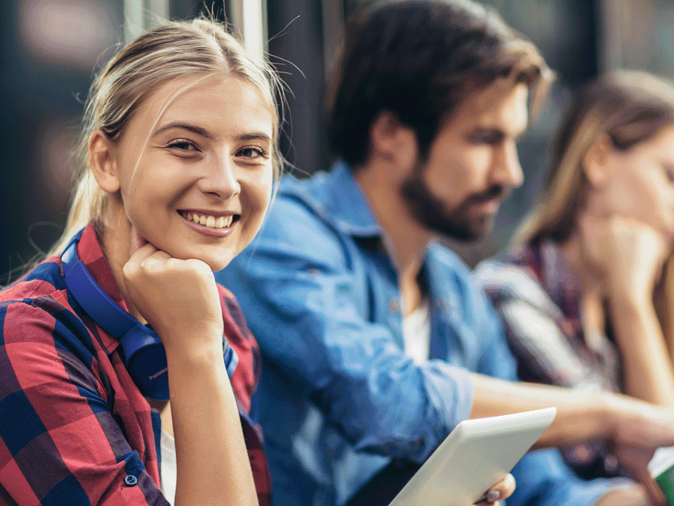 Smiling young person watches to camera.