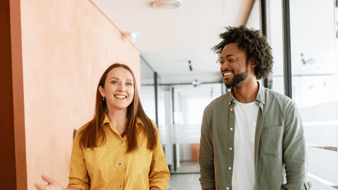 Two colleagues walking in office