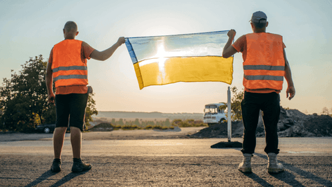 Kaksi ukrainalaista rakennustyömiestä pitävät Ukrainan lippua
